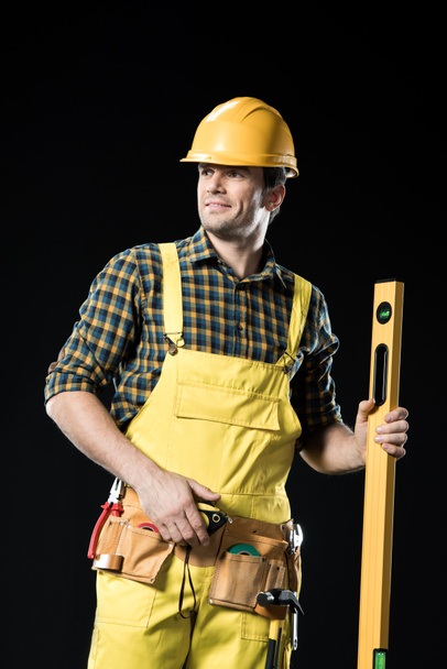 Construction worker with level tool - Fotó, kép