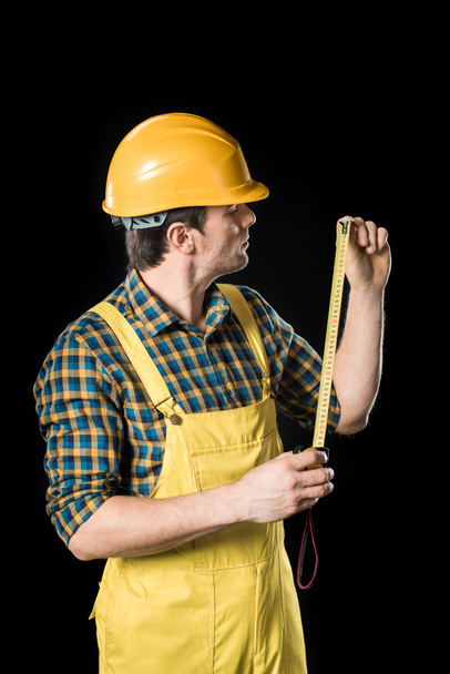 Workman with meter roller - Фото, изображение