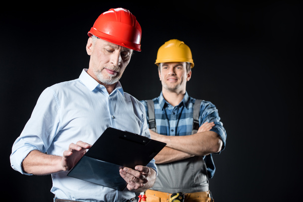 Workman and architect with clipboard - Photo, Image