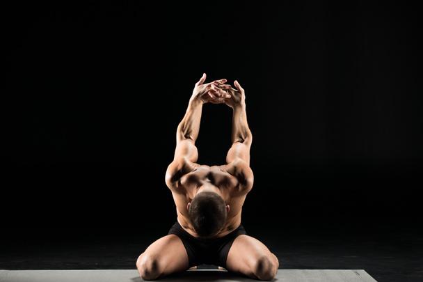 Man sitting in yoga position  - Фото, зображення