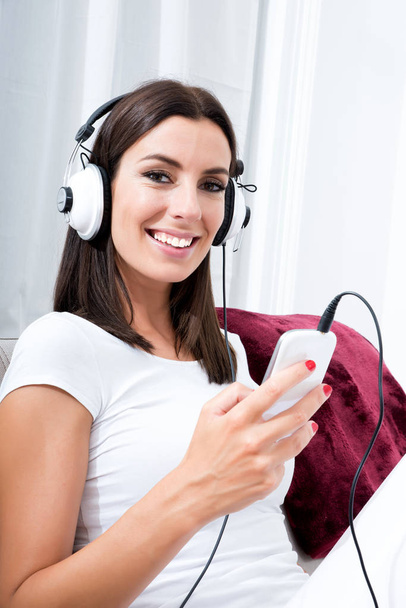 Beautiful young woman in headphones listening to music	 - Fotoğraf, Görsel