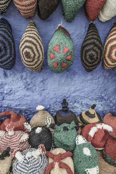 Colorful knit hats hanged on wall - Photo, Image