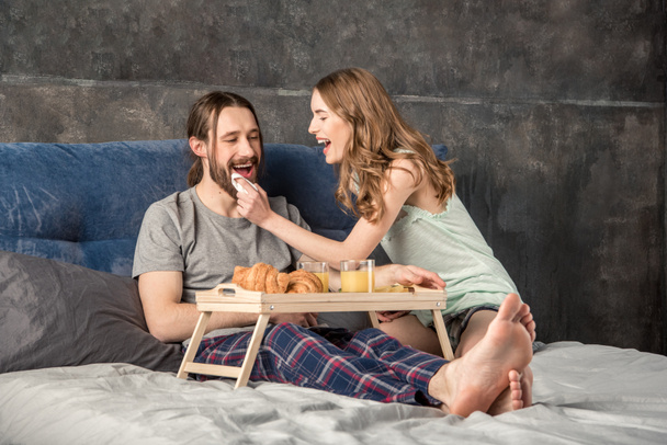Couple has breakfast in bed - Фото, зображення