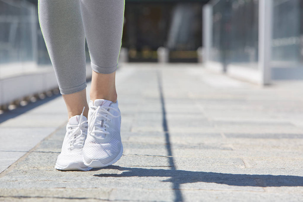 Woman running with white shoes outdoor, sunlight - Foto, Imagem