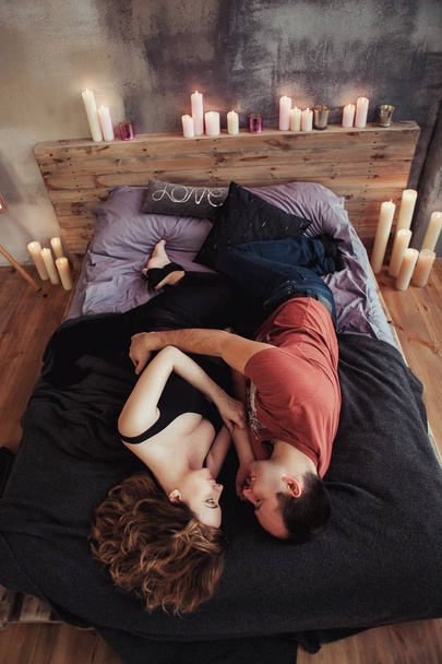 Blick von oben, junges Paar umarmt sich im Bett, zärtlich. die Frau ist schwanger - Foto, Bild