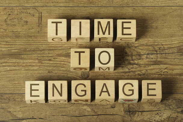 time to engage text on cubes on wooden background - Photo, Image