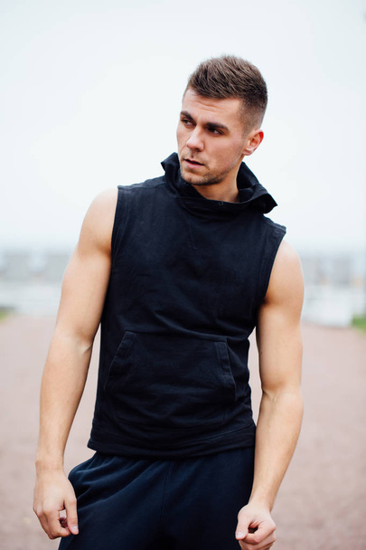 handsome young muscular sports man on city park background, posing, - Foto, Imagem