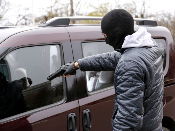 Male thief with pistol   - Foto, imagen