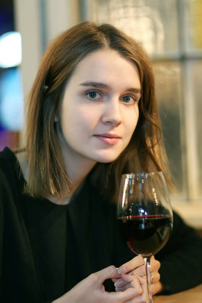 Closeup portrait of a pretty girl with a glass - Photo, Image
