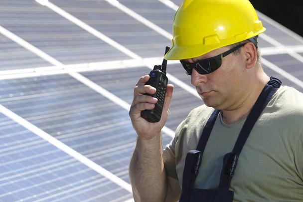 Green energy, solar panel and worker with walkie talkie - Foto, afbeelding