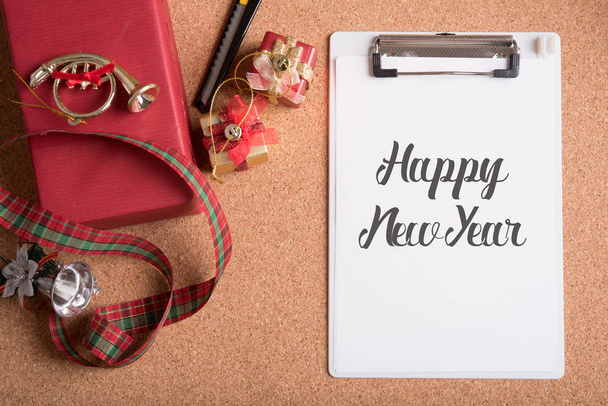 записная книжка со словом happy new year and holiday decoration on woo
 - Фото, изображение
