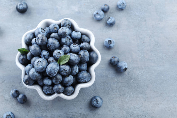 Ripe and tasty blueberries in bowl - Фото, изображение