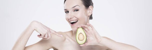 Woman pointing at an avocado - Фото, зображення