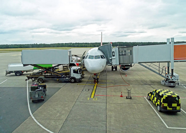 An aircraft is prepared on the apron of an airport for departure  - Foto, Bild