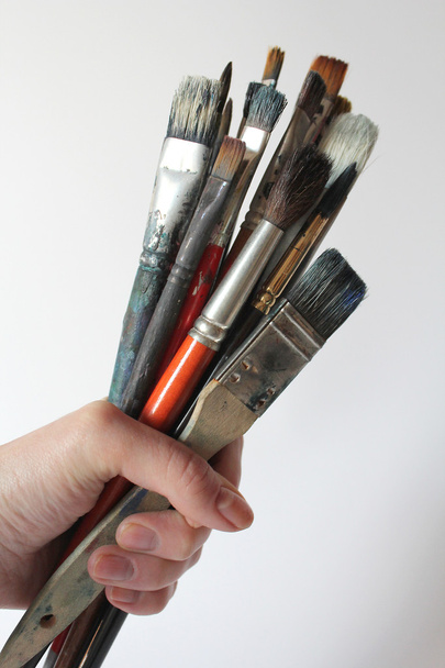 Bunch of stained brushes in woman hand - Photo, Image