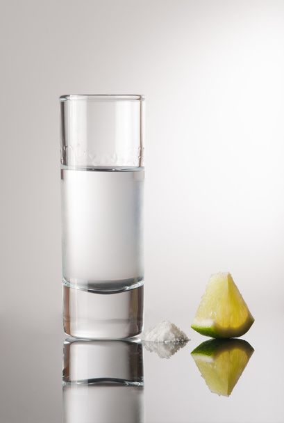 Tequila in a glass with a slice of lemon - Foto, imagen