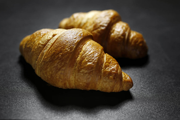 closeup of croissants on black background - Photo, Image