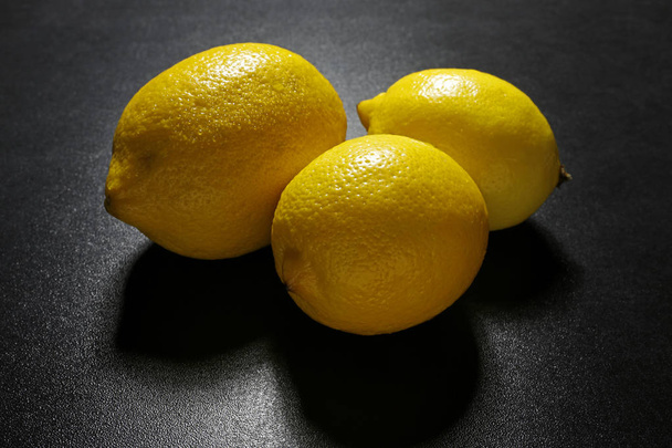 group of lemons friuts on black background - Фото, изображение