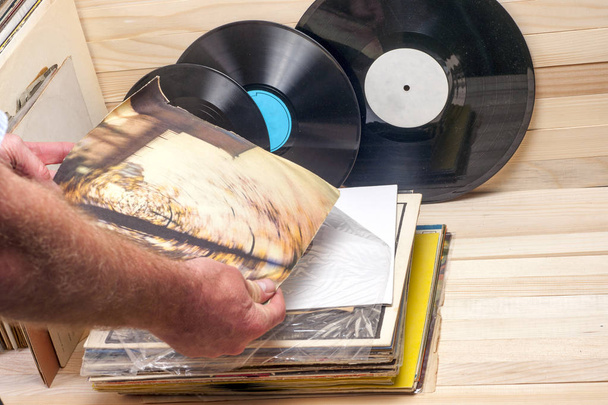 Browsing through vinyl records collection. Music background. Copy space - Photo, Image