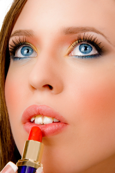 Female applying lipstick - Φωτογραφία, εικόνα