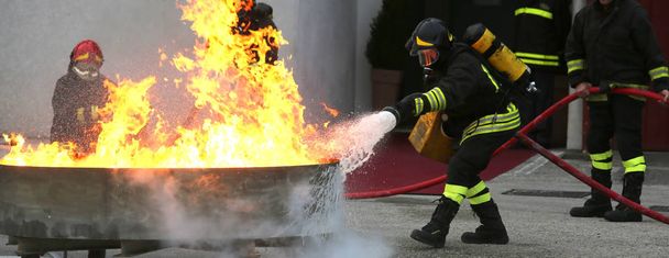firefighters during the exercise to extinguish a fire with foam - Photo, Image