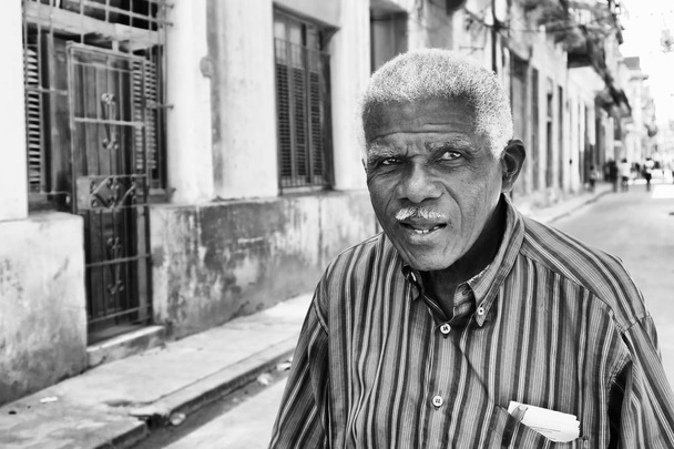 an elderly Cuban man walking and talking  - Photo, Image