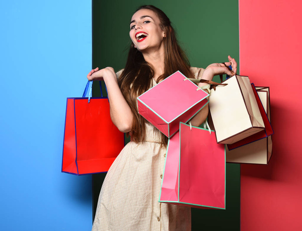 smiling colorful girl with bags - 写真・画像