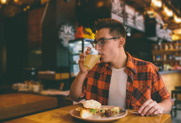 Man eating in a restaurant and enjoying delicious food - Фото, изображение