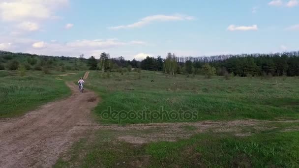 little girl rides bicycle on country road - Footage, Video