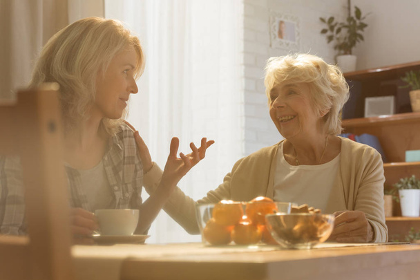 Woman talking with old mother - Photo, Image