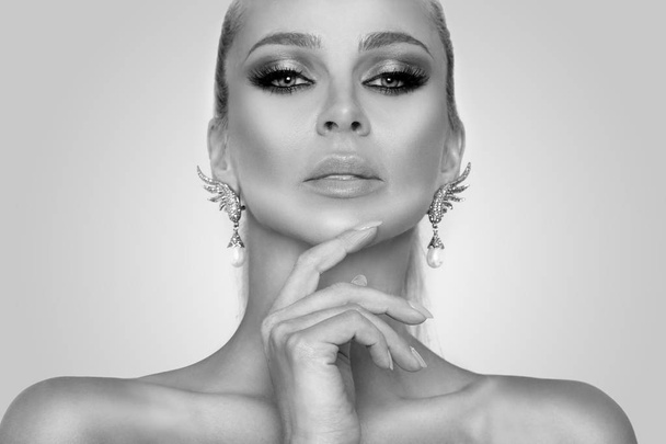 Portrait of the beautiful sexy elegant woman with amazing eyes and a perfect face in a beautiful makeup and perfect skin and nails manicured  - Photo, Image