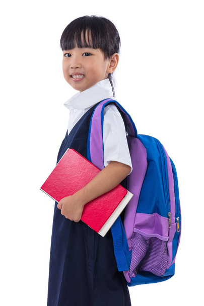 Asian Chinese little primary school girl holding books with bag - Fotoğraf, Görsel