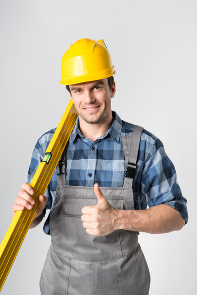 Workman with level tool - Фото, зображення