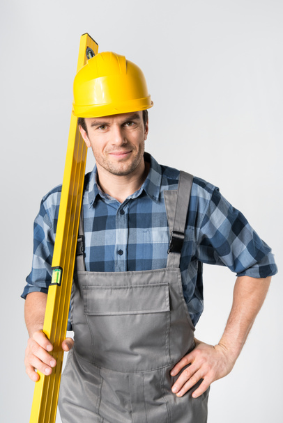 Workman with level tool - Foto, Bild