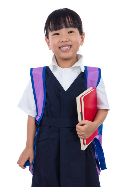 Asian Chinese little primary school girl holding books with bag - Photo, image