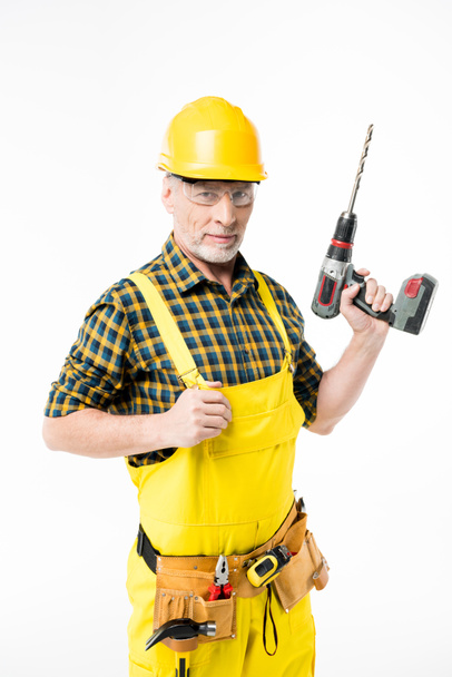 Workman holding electric drill - Fotoğraf, Görsel