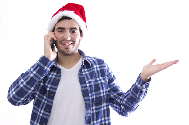 young man with mobile phone and santa hat - Zdjęcie, obraz