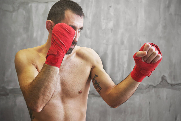 Shot of wrapped hands  with red boxing tape of young boxer fight - Photo, Image