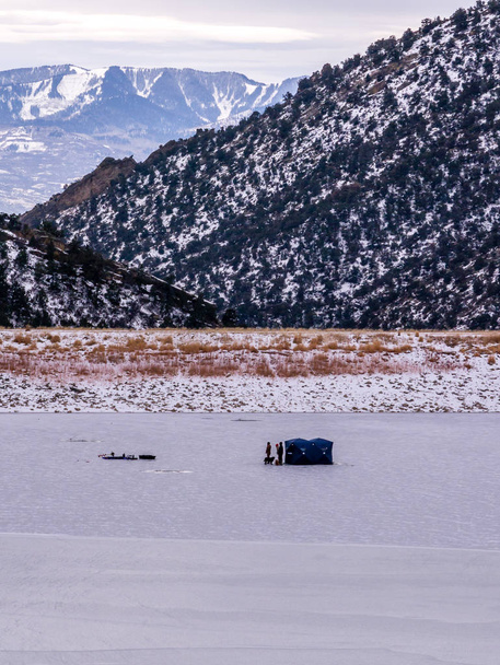 Men Ice Fishing on Frozen Lake - Photo, Image