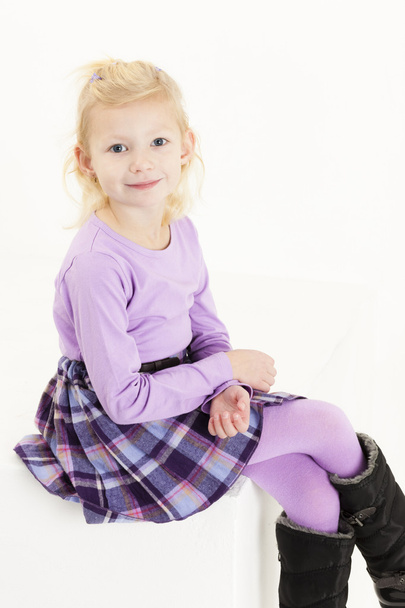 Little girl wearing boots sitting on chair - Φωτογραφία, εικόνα