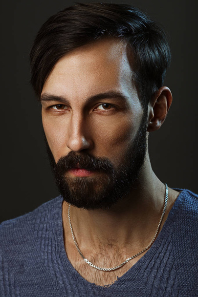 Low key portrait of suspicious man with beard - Photo, image