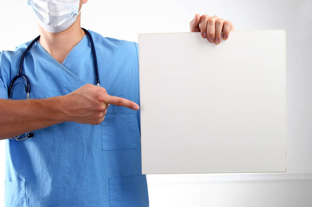 Doctor holding blank banner , standing on white background - 写真・画像