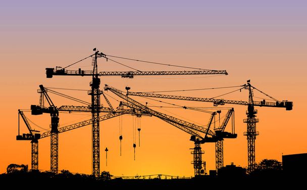 silhouette of construction tower crane with sunset sky background - Photo, Image