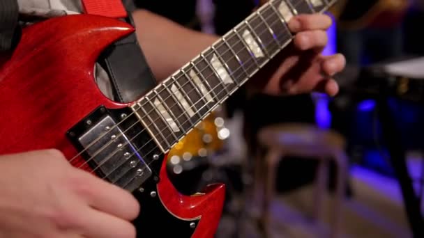 Close up view of guitarist plays electro guitar in night club - Footage, Video