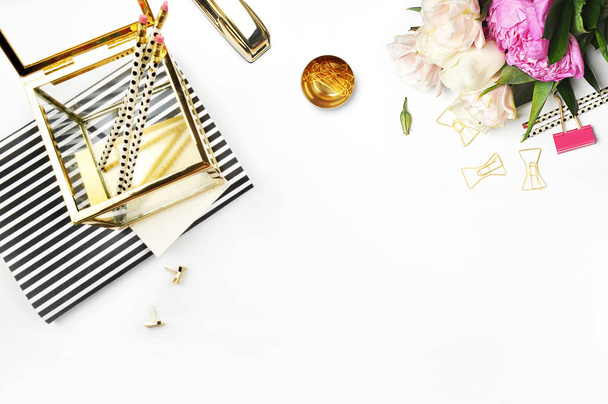 Flat lay. Flower on the table.Gold stapler. Table view. Mock-up background. Peonies. Stationery. Stripe notebook with gold box. - Photo, Image
