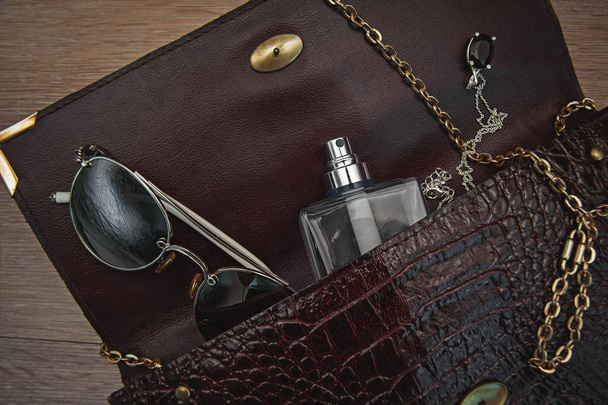Top view of female fashion accessories. Perfume with sunglasses - 写真・画像
