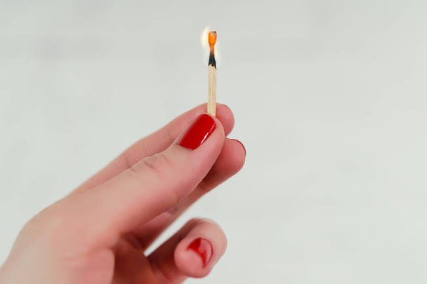 woman holding a burning match - 写真・画像