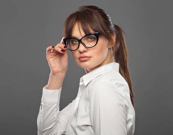 Office and business style. Lady in glasses. Goal oriented girl. She takes  by hand. Portrait in the studio. - Fotografie, Obrázek