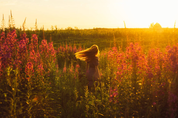 Танцююча красива дівчина на полі, підсвічування сонця, схід сонця
 - Фото, зображення
