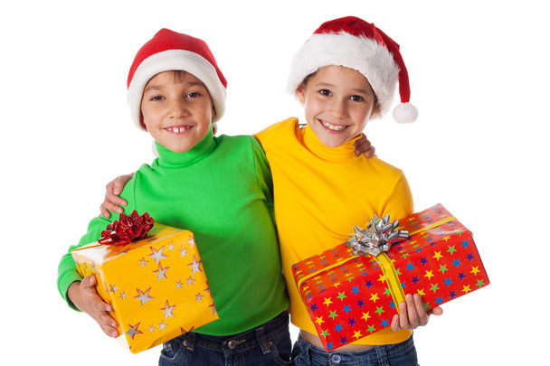 Smiling kids in Santa hats with gift boxes - Foto, Bild